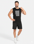 Man wearing a black sleeveless shirt with text and black shorts on a white background