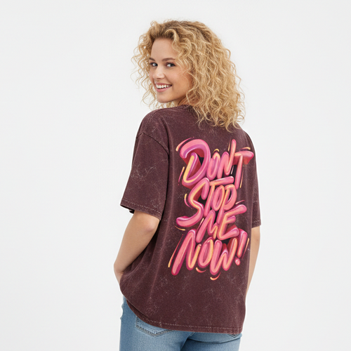 Woman wearing a maroon t-shirt with pink text and blue jeans on a white background
