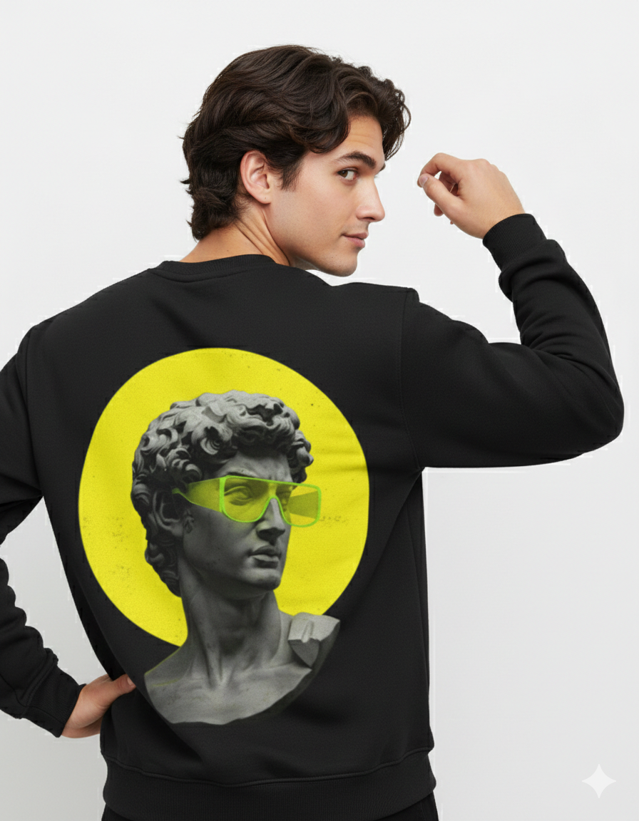 Person wearing a black sweatshirt with a graphic of a classical bust wearing sunglasses on a yellow circle.