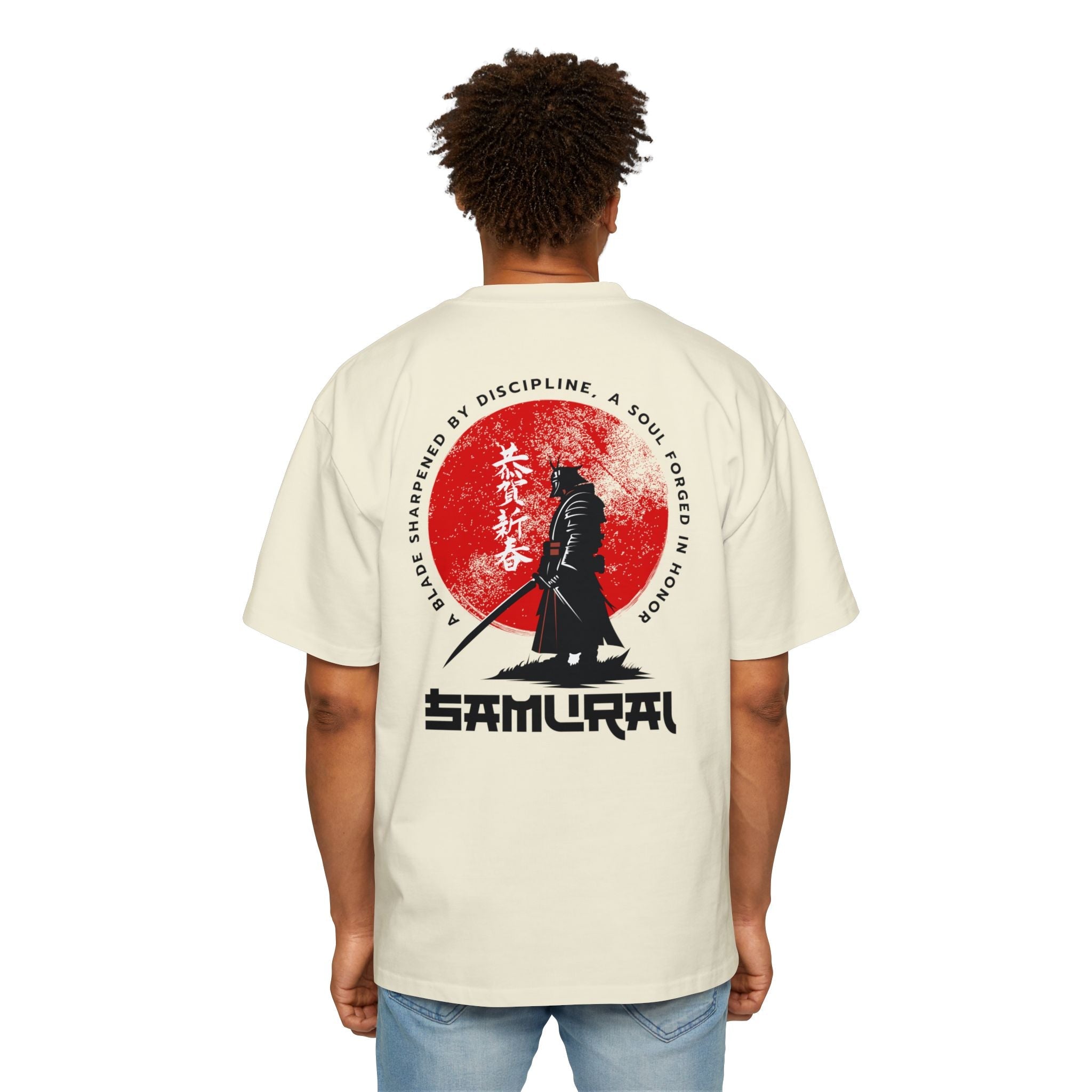 Person wearing a beige t-shirt with a Samurai design on the back