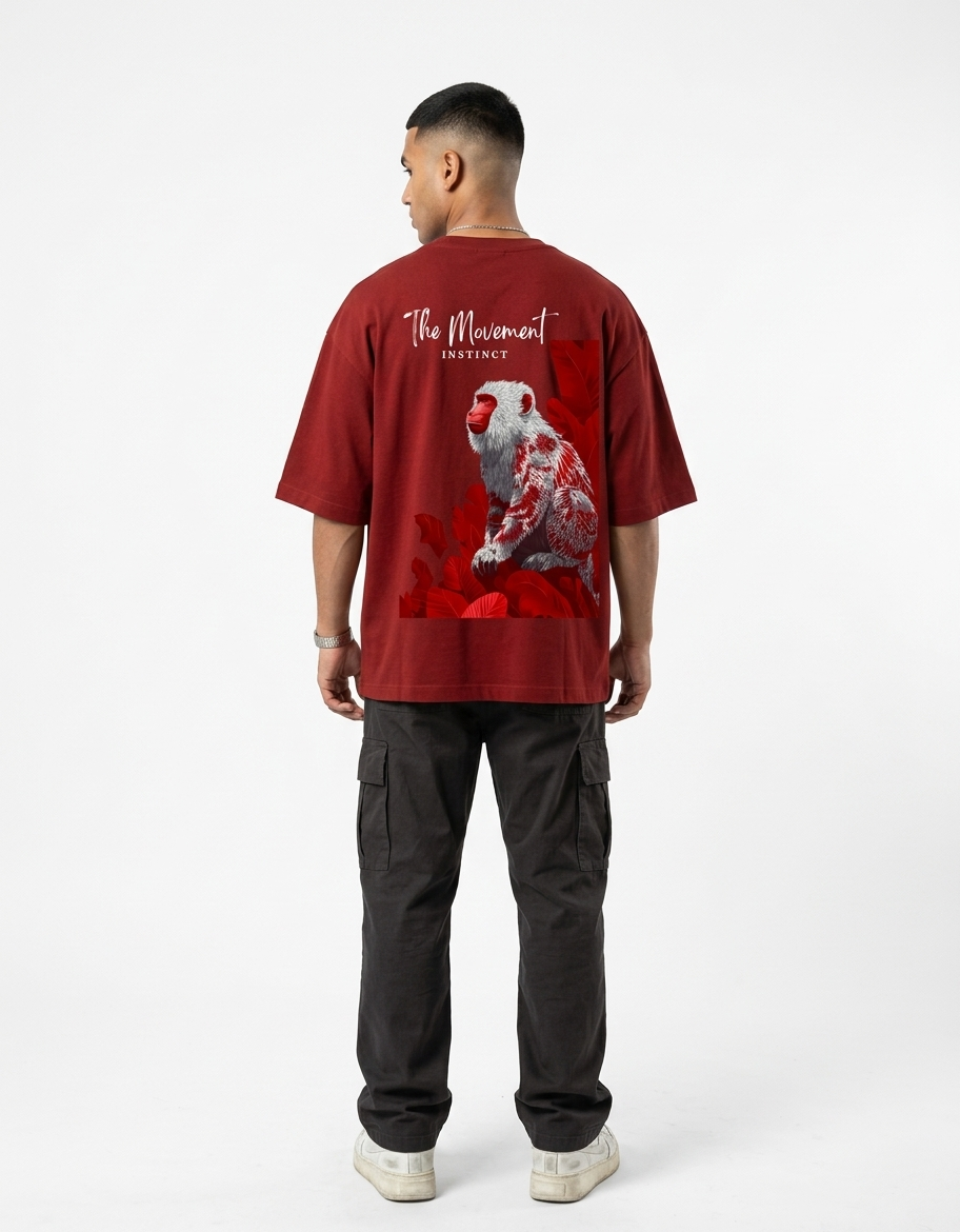 Person wearing a red t-shirt with a parrot design on the back, standing against a white background.